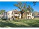 Inviting condominium complex showcasing well-maintained lawns, mature trees, and charming architectural details at 13608 S Village Dr # 6203, Tampa, FL 33618