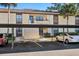 Exterior of a home with reserved parking and tropical landscape at 13608 S Village Dr # 6203, Tampa, FL 33618