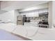 Kitchen featuring white countertops, stainless steel appliances and a stylish backsplash at 13608 S Village Dr # 6203, Tampa, FL 33618