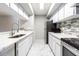 Modern kitchen featuring stainless steel appliances, granite countertops, and white cabinets at 13608 S Village Dr # 6203, Tampa, FL 33618