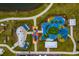 Aerial view of the colorful and modern playground, featuring a splash pad and various play structures at 13608 S Village Dr # 6203, Tampa, FL 33618