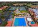 Aerial view of resort style community amenities, featuring a pool, clubhouse, and tennis courts at 13608 S Village Dr # 6203, Tampa, FL 33618