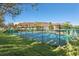 Beautiful blue and green community tennis court nestled amongst shady mature trees in daylight at 13608 S Village Dr # 6203, Tampa, FL 33618