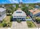 Aerial view of a two-story home with a unique metal roof and a water view at 13974 75Th Ave, Seminole, FL 33776
