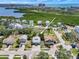 Beautiful aerial view of the home with a pond and mature landscaping, and a water view in the distance at 13974 75Th Ave, Seminole, FL 33776