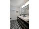 Modern bathroom with a double sink vanity, statement tile flooring, and a bright window, balancing function with style at 13974 75Th Ave, Seminole, FL 33776