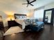 Relaxing bedroom with hardwood floors, tropical bedding, ceiling fan and ample natural light at 13974 75Th Ave, Seminole, FL 33776