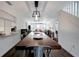 Open-concept dining room with hardwood floors, modern light fixture and ample seating at 13974 75Th Ave, Seminole, FL 33776