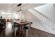Spacious dining area with modern light fixture, staircase and hardwood floors at 13974 75Th Ave, Seminole, FL 33776