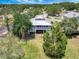 Charming home with a metal roof, covered porch, mature landscaping, and a spacious front yard at 13974 75Th Ave, Seminole, FL 33776