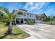 Charming stilt home with large driveway and lush tropical landscaping in desirable location at 13974 75Th Ave, Seminole, FL 33776