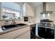 Updated kitchen with stainless steel appliances, white cabinets and granite counters at 13974 75Th Ave, Seminole, FL 33776