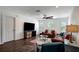 A bright living room offers hardwood floors, stylish storage, and a unique circular window that complements its cozy design at 13974 75Th Ave, Seminole, FL 33776