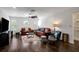 This living room features hardwood floors, leather furniture, and a striking circular window for natural light and stylish charm at 13974 75Th Ave, Seminole, FL 33776