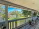 Covered porch with scenic views of the pond and surrounding trees at 13974 75Th Ave, Seminole, FL 33776