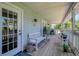Inviting outdoor porch with bench seating and access to the home's interior at 13974 75Th Ave, Seminole, FL 33776