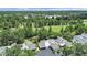 Aerial view of modern townhomes with garages nestled in a lush, green, tree-filled golf course community at 14205 Cypress Ter, Tampa, FL 33618