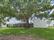 A large backyard featuring mature trees and a screened patio for outdoor relaxation at 14205 Cypress Ter, Tampa, FL 33618