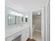 Bathroom vanity with marble countertop and white cabinets next to toilet room at 14205 Cypress Ter, Tampa, FL 33618