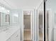 Bathroom view of the vanity, sink, mirror and the toilet room behind at 14205 Cypress Ter, Tampa, FL 33618