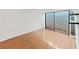 Well lit bedroom featuring wood floors, a large window, and minimal decoration at 14205 Cypress Ter, Tampa, FL 33618