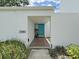 View of the exterior featuring a bright blue door and neutral landscaping at 14205 Cypress Ter, Tampa, FL 33618