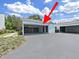 Home exterior with a two-car carport, modern design, and neat landscaping at 14205 Cypress Ter, Tampa, FL 33618