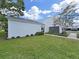 Home's exterior with well manicured lawn and low shrubbery outlining the sidewalk at 14205 Cypress Ter, Tampa, FL 33618