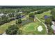 Scenic golf course view with mature trees and a serene pond, providing a tranquil backdrop at 14205 Cypress Ter, Tampa, FL 33618