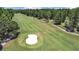 Expansive golf course view, featuring lush fairways, mature trees, and a sand bunker at 14205 Cypress Ter, Tampa, FL 33618