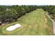 Wide view showcases a golf course with lush green fairways, mature trees, and a sand bunker at 14205 Cypress Ter, Tampa, FL 33618
