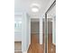 Hallway view of bathroom and bedroom with sliding door closet and wood look floors at 14205 Cypress Ter, Tampa, FL 33618