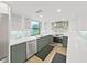 Spacious kitchen featuring stainless steel appliances, gray cabinets and stone countertops at 14205 Cypress Ter, Tampa, FL 33618