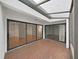 Lanai with brick floor, glass roof and sliding glass doors to the interior at 14205 Cypress Ter, Tampa, FL 33618