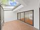 Sunroom with a skylight, brick floor and multiple sliding glass doors at 14205 Cypress Ter, Tampa, FL 33618