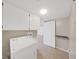 Well lit laundry room featuring a washer and dryer with overhead cabinets at 14205 Cypress Ter, Tampa, FL 33618