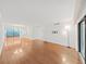 Open-concept living area featuring hardwood floors and access to the exterior patio through sliding glass doors at 14205 Cypress Ter, Tampa, FL 33618