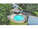 Aerial view of a community pool with lounge chairs surrounded by lush landscaping and fencing at 14205 Cypress Ter, Tampa, FL 33618
