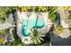 Relax in the community's inviting pool with palm trees and lounge chairs at 1476 Harbour Walk Rd, Tampa, FL 33602