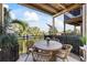 Charming balcony with outdoor seating and scenic views of the harbor and palm trees at 1476 Harbour Walk Rd, Tampa, FL 33602
