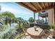 Inviting balcony with wicker furniture and a serene view of palm trees and the water at 1476 Harbour Walk Rd, Tampa, FL 33602