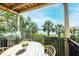 Relaxing balcony with wicker furniture, lush greenery, and a view of the water and palm trees at 1476 Harbour Walk Rd, Tampa, FL 33602