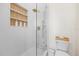Bright shower with a glass enclosure, white tile, and built-in shelving at 1476 Harbour Walk Rd, Tampa, FL 33602