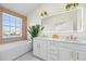 Bright bathroom with double vanity, modern fixtures, and a large window with water views at 1476 Harbour Walk Rd, Tampa, FL 33602