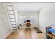 Bright bedroom with wood floors, ladder access to loft, home office and workout area at 1476 Harbour Walk Rd, Tampa, FL 33602