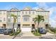 Charming townhomes featuring attached garages, manicured landscaping, and neutral color schemes at 1476 Harbour Walk Rd, Tampa, FL 33602