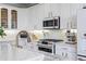 Close-up of a modern kitchen with white cabinetry, marble counters, and stainless steel appliances at 1476 Harbour Walk Rd, Tampa, FL 33602