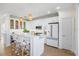 Elegant kitchen with white cabinets, marble counters, stainless appliances, and island seating at 1476 Harbour Walk Rd, Tampa, FL 33602