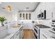 Beautiful kitchen with white cabinets, marble counters, an island, and stainless steel appliances at 1476 Harbour Walk Rd, Tampa, FL 33602