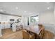 Open concept kitchen and dining area with an island, wooden table, and natural light at 1476 Harbour Walk Rd, Tampa, FL 33602